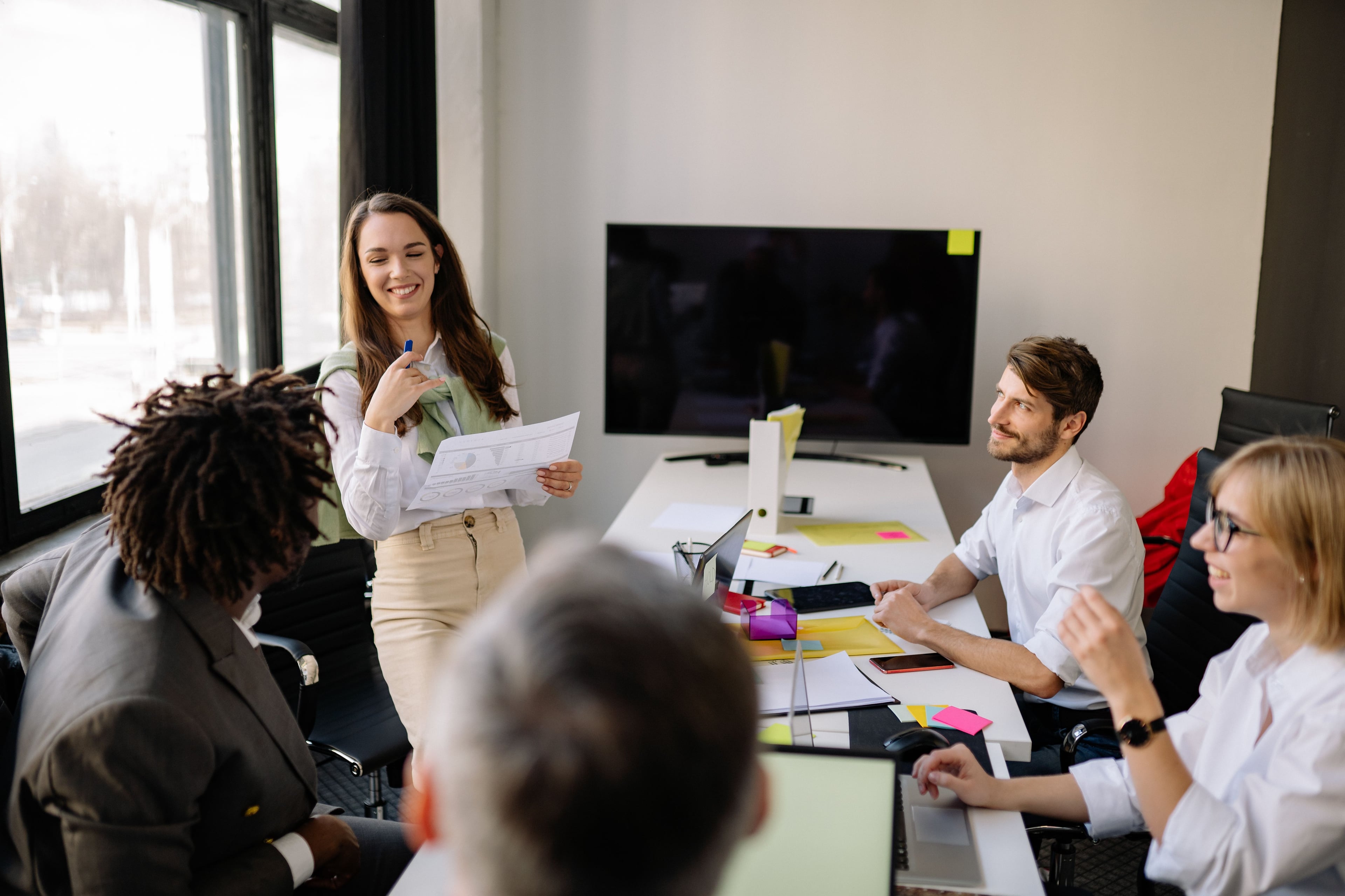 A colleague facilitating a discussion with printed material