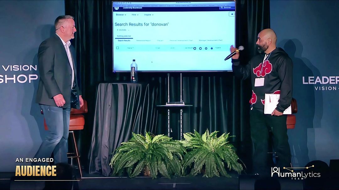 Mike McCloskey speaking with a participant on stage.