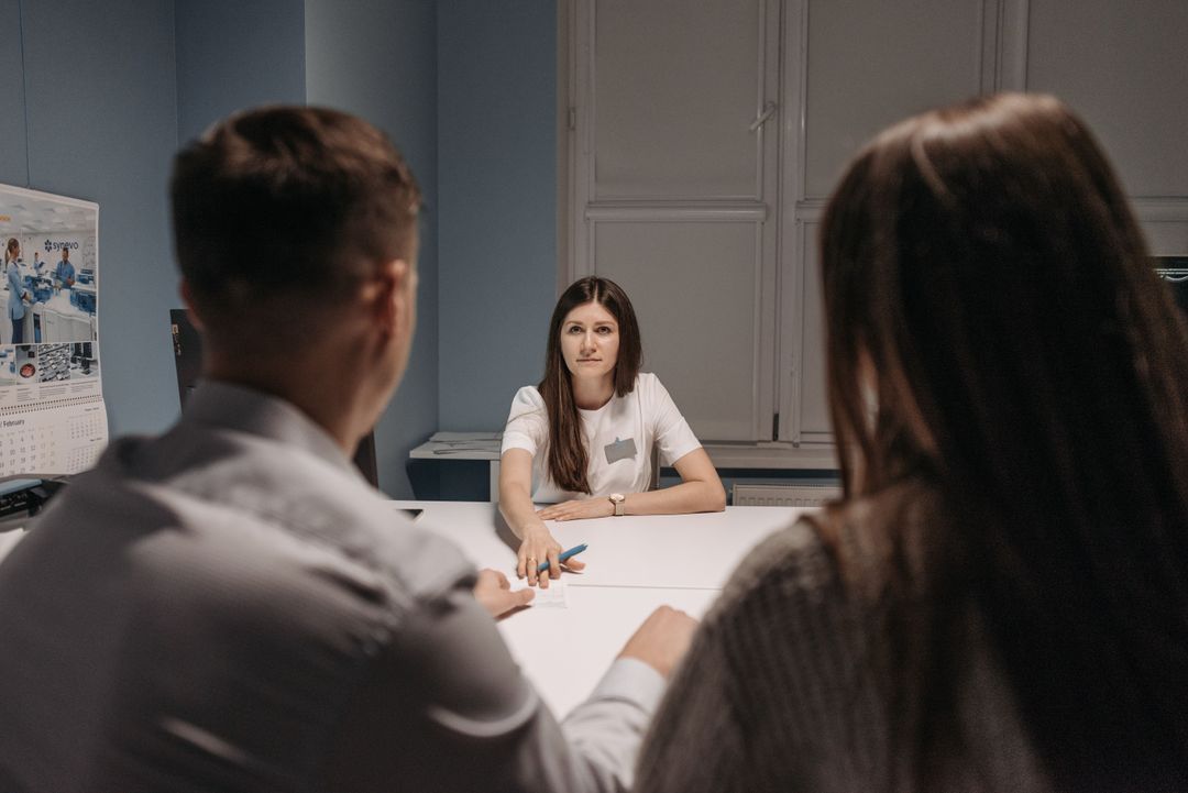 A healthcare professional in a discussion around a table