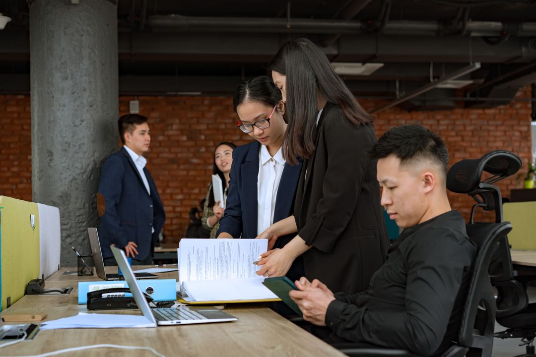 Colleagues comparing information in a document